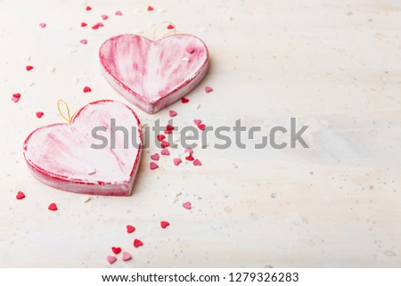 Valentines day background with two red shabby hearts on light background. Space for text.