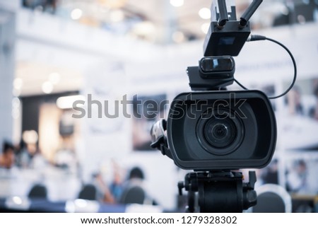 Film lens of Video camera recording film shooting of grand opening in conference hall Live streming wifi microphone sending for presentation with bokeh light background. Media Production Concept