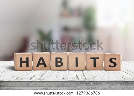 What is your habits? Sign with the word habits on a wooden desk in a bright room Royalty-Free Stock Photo #1279366786