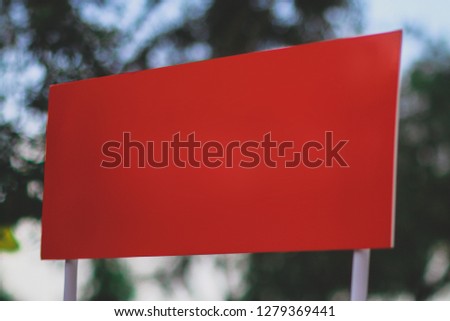 empty blank red sign banner board mockup isolated with blurred background 