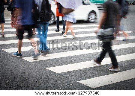 Busy city street people on zebra crossing Royalty-Free Stock Photo #127937540