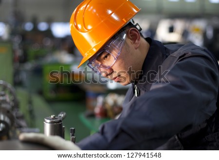Technician working in factory shallow in focus