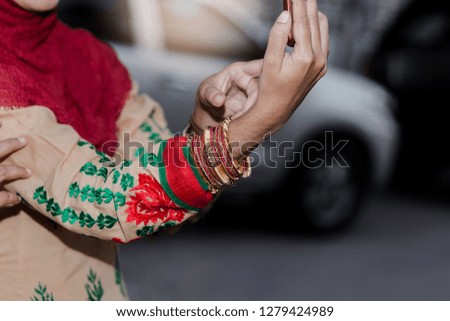 Muslim female hands using smart phone.