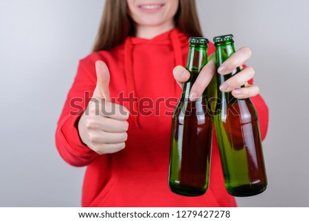 Cropped closeup photo of positive cheerful pretty confident satisfied advertising millenial use thumbup hold glass in hand isolated gray background