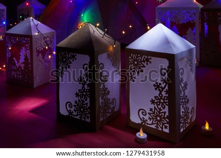 The colorful holiday paper lights. Holiday background.