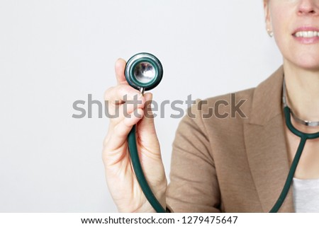 woman doctor with stethoscope on grey background stock photo