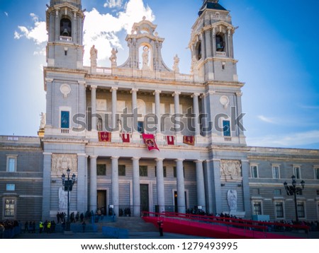 A photo of the Almudena cathedral with beautiful red ornaments on the Almudena day, Dia De La Almudena, on November 9, which is a very important celebration day for people living in Madrid, Spain. 