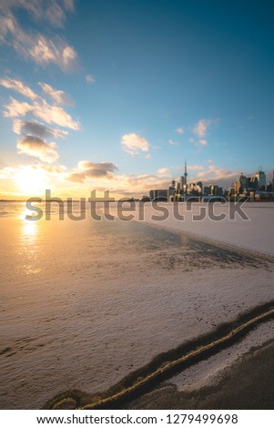 View of Toronto Skyline in the Winter with Lake Ontario covered with snow
