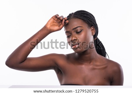 Close up portrait of beautiful african girl touching her smooth soft flawless perfect skin on cheek isolated on white background