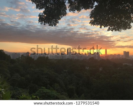 Beautiful sunrise of Kuala Lumpur City from Bukit Tunku. With the silhouette skyscraper building as background. the pictures may have some noise due to taken during low light.