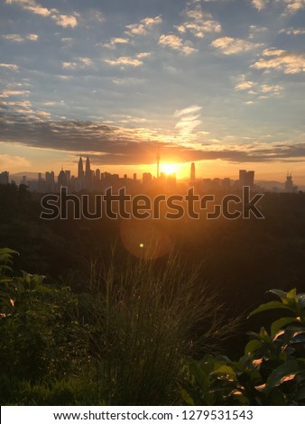 Beautiful sunrise of Kuala Lumpur City from Bukit Tunku. With the silhouette skyscraper building as background. the pictures may have some noise due to taken during low light.