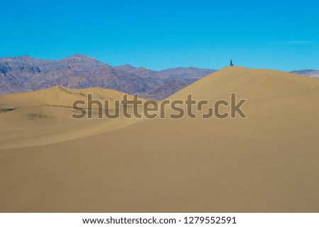 lone person atop death valley sand dune