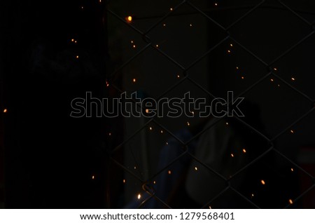 welding steel with sparks lighting in the dark background. 