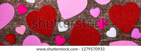 Valentines Day Background. Valentines Day Fabric Hearts Shaped on Wooden Background. Panoramic image. Selective focus.