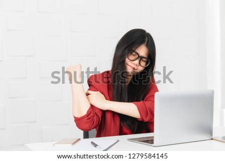 Young attractive Asian businesswoman, long black hair, wearing glasses, ache about customer orders in hand, with notebook on white office background