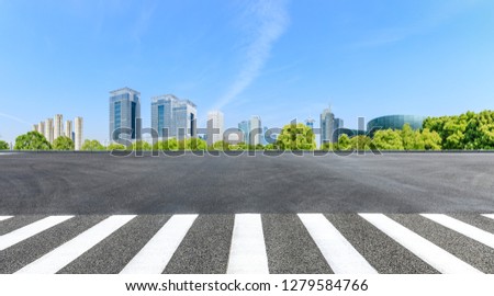 City zebra crossing road and modern commercial buildings in Shanghai