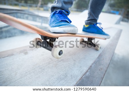 skateboarding legs riding skateboard at skatepark