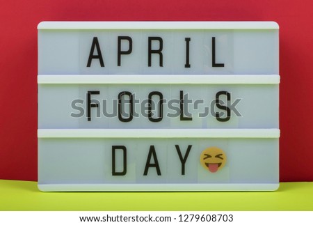 April Fool's day lettering on Lightbox on Red and Yellow background. 