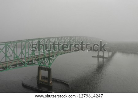 bridge in fog and river