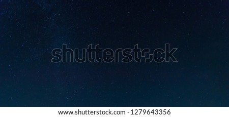 Photo by long exposure and select white balance.Dark night sky.Panorama blue night sky milky way and star on dark background.Universe filled with stars, nebula and galaxy with noise and grain.