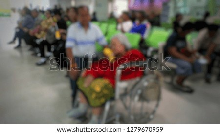 Many patients ... are sitting on a wheelchair, sitting on the chair   ... to wait to see a doctor and receive medical services from the hospital ... lens blurred