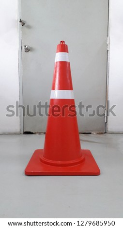 Red plastic of traffic cones isolated on the door background