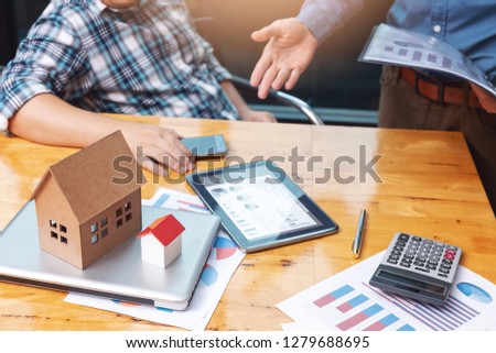 Real estate agent showing his client about property detail.