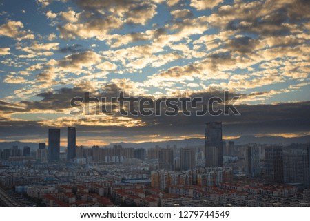 Urban real estate concept: city on twilight color sky and clouds cityscape background