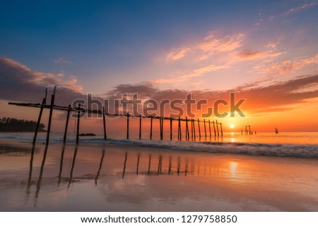 Seascape of Old wooden bridge at sunset time in Phangnga, Thailand.