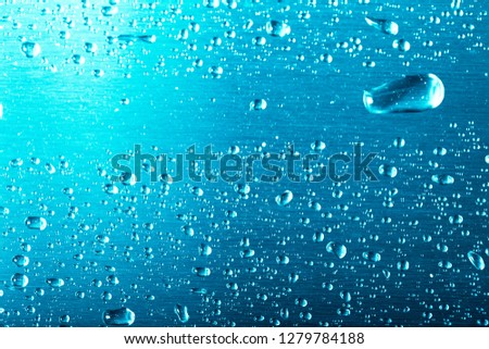 Drops of water on a color background. Gray. Shallow depth of field. Selective focus. Blur