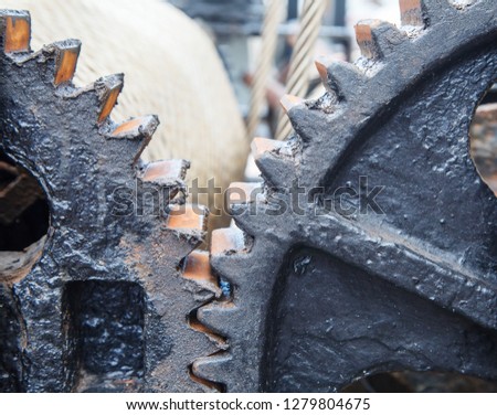 large steel greased gears in a single mechanism