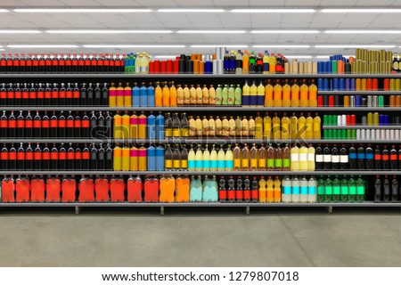 Soda pop cans and plastic cola bottles on shelves. Suitable for mockup and business presentation. Royalty-Free Stock Photo #1279807018