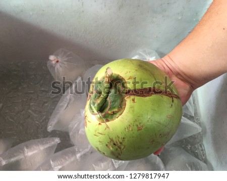 The coconut is stored in an ice bucket.