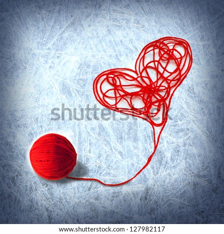 Red heart made of wool thread on ice. Valentine day greeting, card, poster