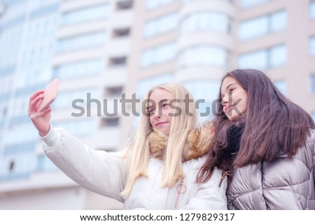 two girls make selfie, smile on face, house background