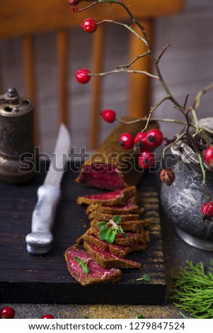 Caucasian basturma with spices  on a chopping board. Style rustic. Selective focus
