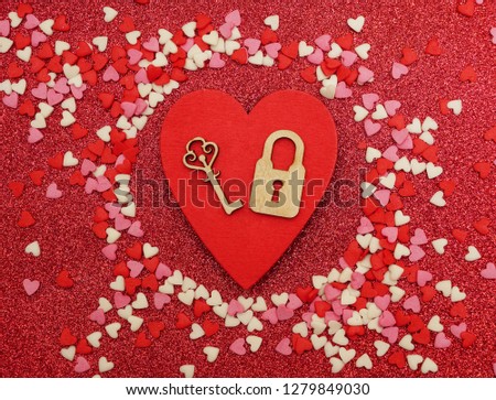 Valentines design - Locked red wooden Heart . Love concept Image with heart with keyhole and vintage key on wood background. happy Valentines day