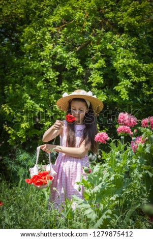 Girl on the field with poppies