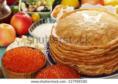 big stack of pancakes with red caviar Royalty-Free Stock Photo #127988180
