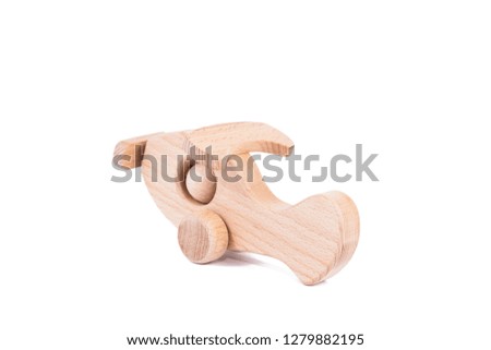 Photo of a wooden plane  of beech. Toy made of wood retro aircraft on a white isolated background