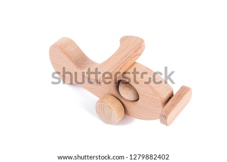 Photo of a wooden plane  of beech. Toy made of wood retro aircraft on a white isolated background