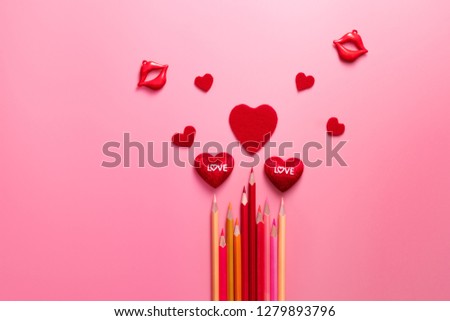 Valentine Day concept, red hearts and color pencil on pink background