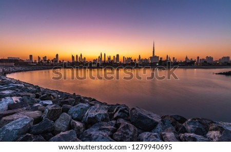 Sunrise View of the Dubai Skyline from La Mer Beach. 