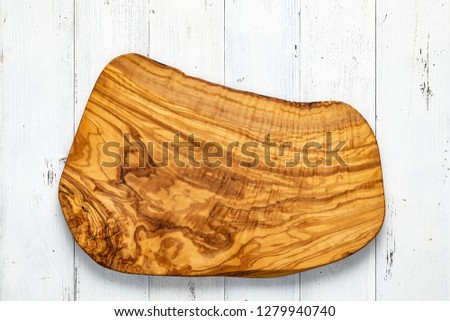 Handmade olive wood chopping board on white board. Olive wood natural texture.