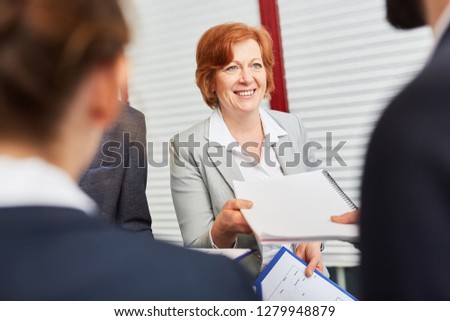 Personnel manager accepts application from candidate in assessment center