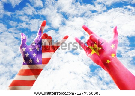 United stage and China flag overlay on two hands show dumb language hand love with cloudy sky background, economic concept 