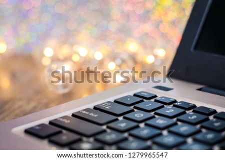 Laptop keyboard side view, selective focus, with gold tones and bokeh background, room for text copy