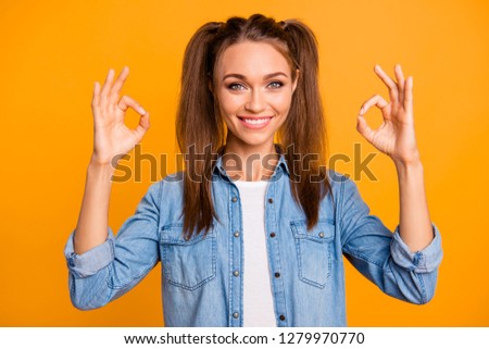 Close up photo of beautiful brunette she her lady pretty hairdo okey gesturing test completed advising new cell phone mobile wearing casual jeans denim shirt outfit isolated on yellow background