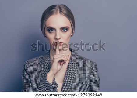Close up photo of attractive she her lady finger close to mouth ask to stop talking speaking telling wearing formalwear checkered strict blazer isolated on grey background