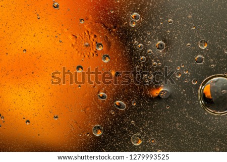 Abstract bright colorful background with oil drops of different sizes and shapes and variety waves on blurry colored gradient water surface, for your creative design